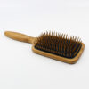 Henna color lab bamboo wood pin paddle brush. Angled view to show depth of bristles.