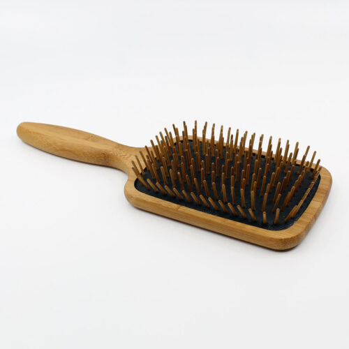 Henna color lab bamboo wood pin paddle brush. Angled view to show depth of bristles.