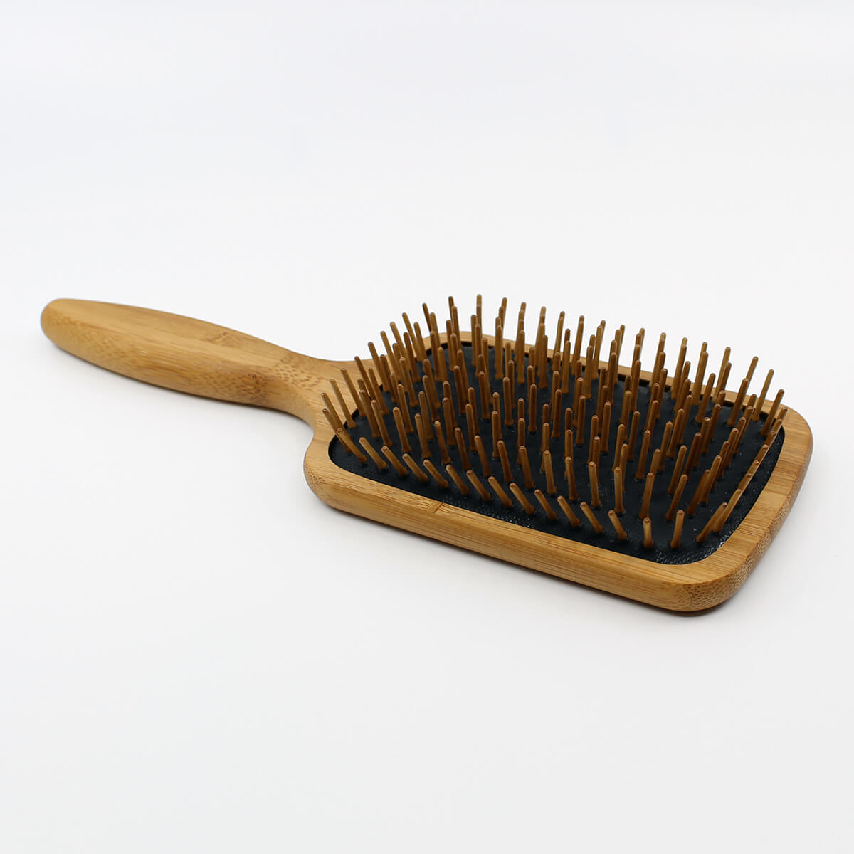 Henna color lab bamboo wood pin paddle brush. Angled view to show depth of bristles.